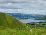 Taste of Medan and Lake Toba_Green Grassy Hill at Lake Toba, Samosir Island, Medan, Indonesia