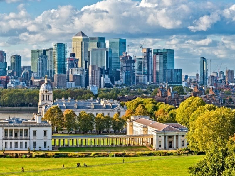Taste of London_England, Panoramic Skyline View Of Greenwich College and Canary Wharf At Golden Hour Sunset With Blue Sky And Clouds
